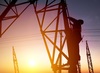 A worker climbing an electrical pylon