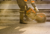 STOCK: road maintenance working in dusty environment
